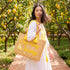 Handwoven Moroccan wicker beach tote with yellow braided handles and Easy Peasy Lemon Squeezy embroidered lemon design summer bag 4