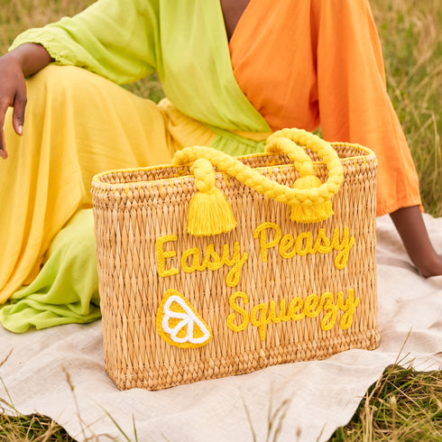 Handwoven Moroccan wicker beach tote with yellow braided handles and Easy Peasy Lemon Squeezy embroidered lemon design summer bag 1