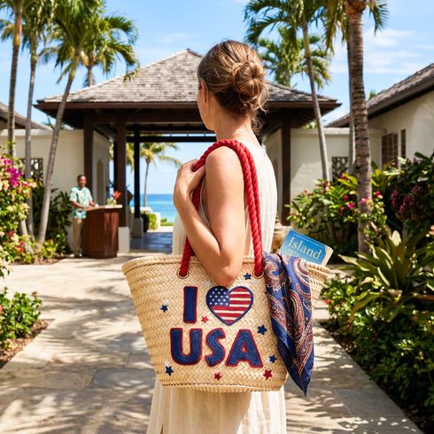 Handwoven straw beach tote with “I Love USA” embroidery and American flag heart, natural palm leaf basket with red rope handles, stylish patriotic travel and summer bag for women