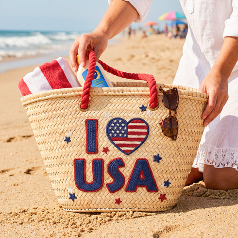 Handwoven straw beach tote with “I Love USA” embroidery and American flag heart, natural palm leaf basket with red rope handles, stylish patriotic travel and summer bag for women