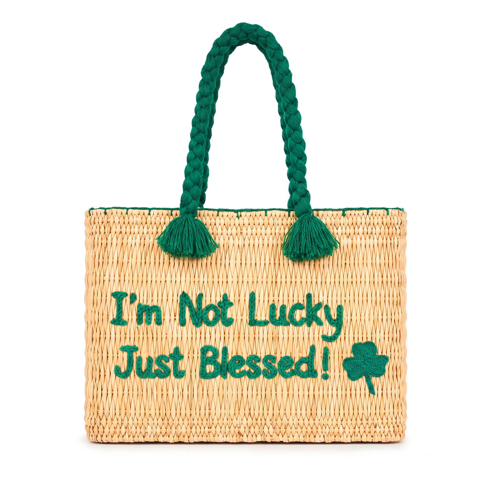 Handwoven Moroccan wicker beach bag with green braided handles embroidered with I’m Not Lucky Just Blessed and shamrock design