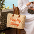 Handmade Moroccan square wicker bag with orange Pimp My Shrimp embroidery, braided brown leather handles, natural straw woven texture, artisan beach tote available in medium and large size 2