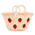 Hand-embroidered straw basket with multiple red strawberries, green leaves, and natural palm leaf texture