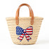 Personalized USA kids straw basket with embroidered American flag bow, small handwoven palm leaf tote with leather handles, custom name on back, patriotic children’s beach and birthday gift bag