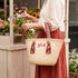 Personalized Moroccan woven straw beach tote with red Amazigh patterned handles and custom initials 5