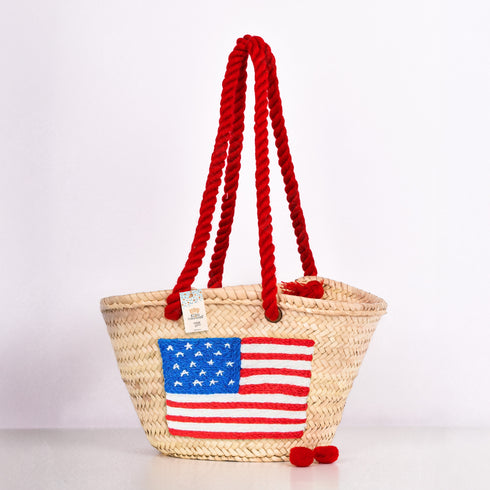 Handwoven straw basket with embroidered USA flag and red braided thread handles