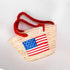 Handwoven straw basket with embroidered USA flag and red braided thread handles