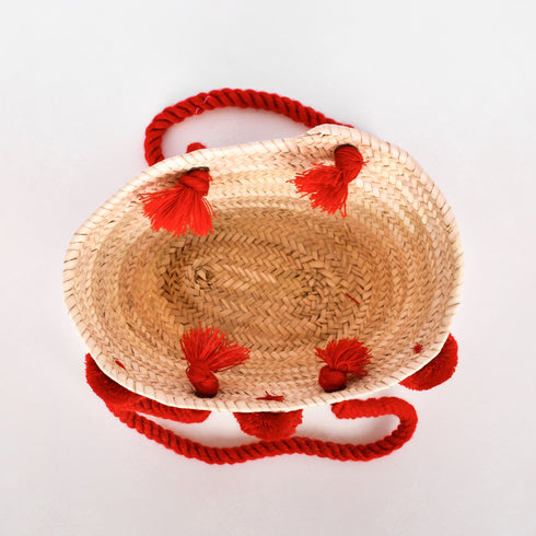Handwoven straw basket with embroidered USA flag and red braided thread handles