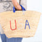 straw basket embroidered with “USA” Eco-friendly tote with blue handle—perfect for beach days, shopping, or patriotic gifts.
