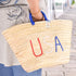 straw basket embroidered with “USA” Eco-friendly tote with blue handle—perfect for beach days, shopping, or patriotic gifts.