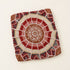 Unstuffed dark tan round fusion pouf cover laid flat, showing red, cream and white Moroccan Amazigh Berber embroidered motifs