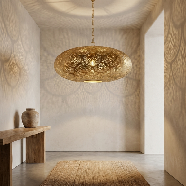 Handmade Moroccan brass pendant light with intricate perforated design casting elegant shadow patterns in a minimalist entryway