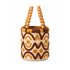 Side view of Moroccan raffia bucket bag showing double wooden bead handles, striped cotton rim and lined interior