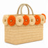 Handmade Moroccan wicker tote bag with braided straw handles and orange and natural raffia flowers on white background