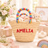 Personalized rainbow baby shower basket with the name AMELIA embroidered in red and rainbow handles, styled with baby gifts