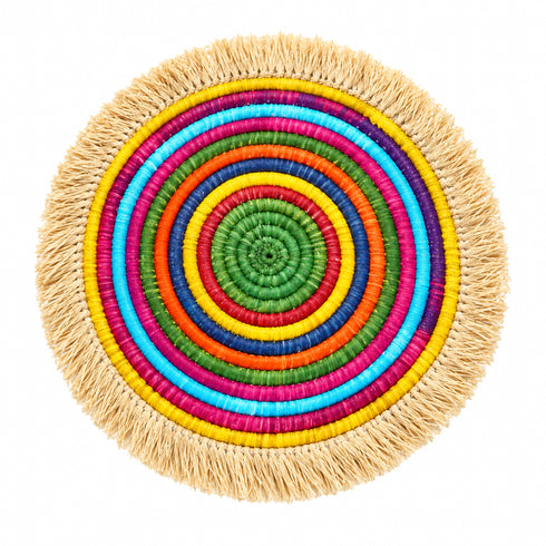 Rainbow concentric woven raffia placemat with natural fringe border, top view on white background