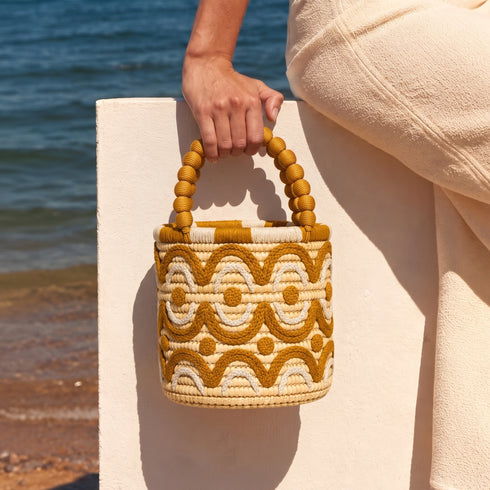 Beige and goldenrod embroidered raffia bucket bag by the sea, a summer resort handbag handmade in Morocco