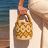 Beige and goldenrod embroidered raffia bucket bag by the sea, a summer resort handbag handmade in Morocco