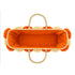 Top view of a handwoven wicker tote bag with orange fabric lining, braided straw handles and raffia flowers around the rim