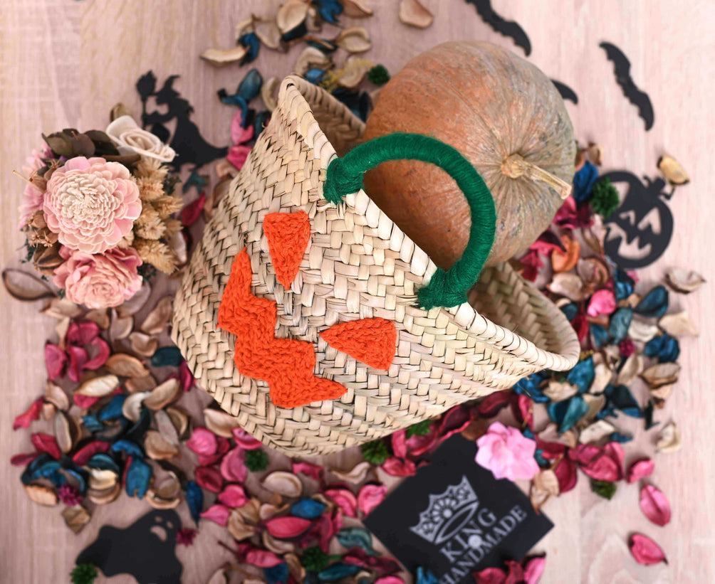 Orange pumpkin basket with a spooky face