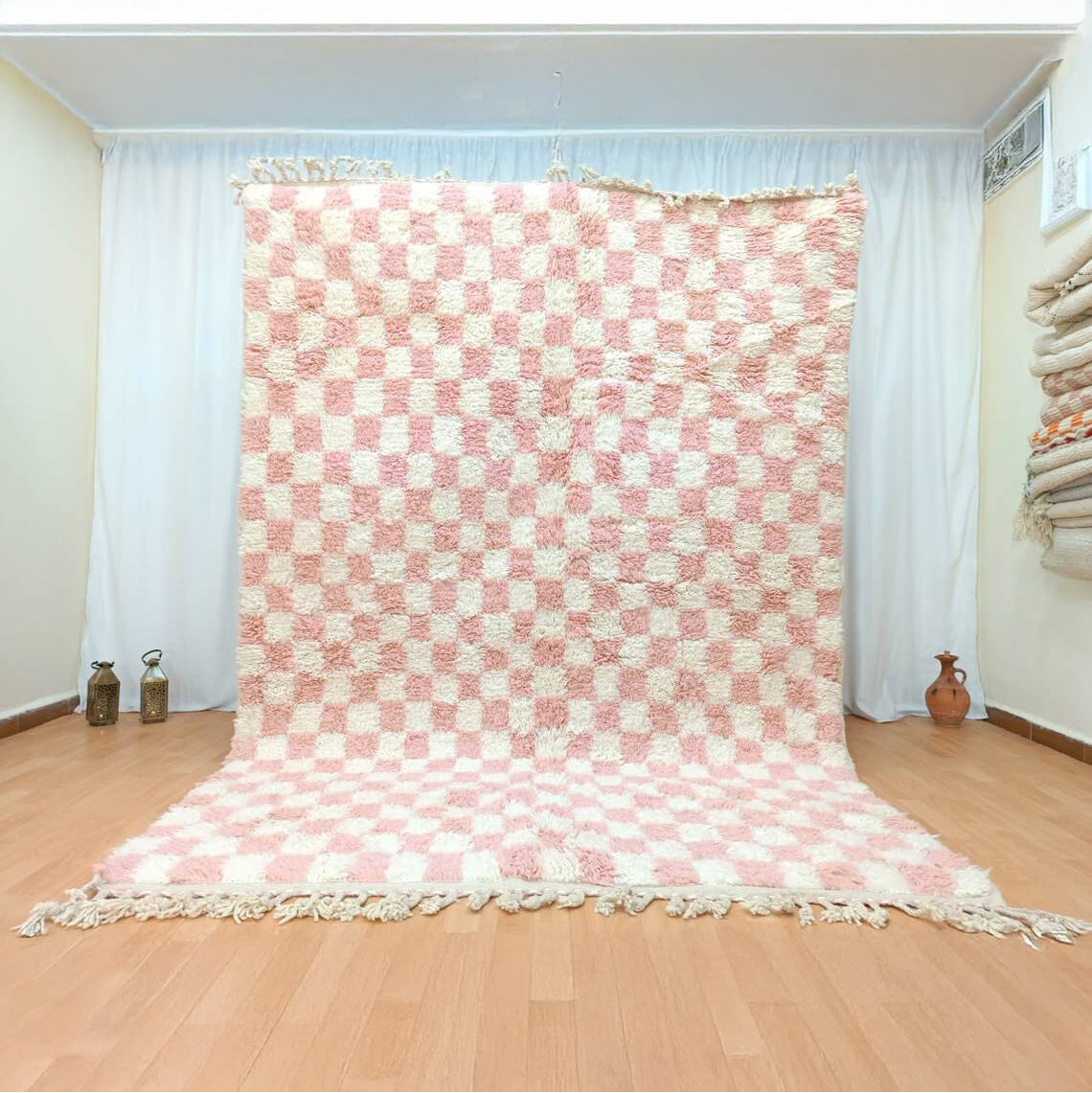 A vibrant pink and green checkerboard patterned handmade Moroccan rug.