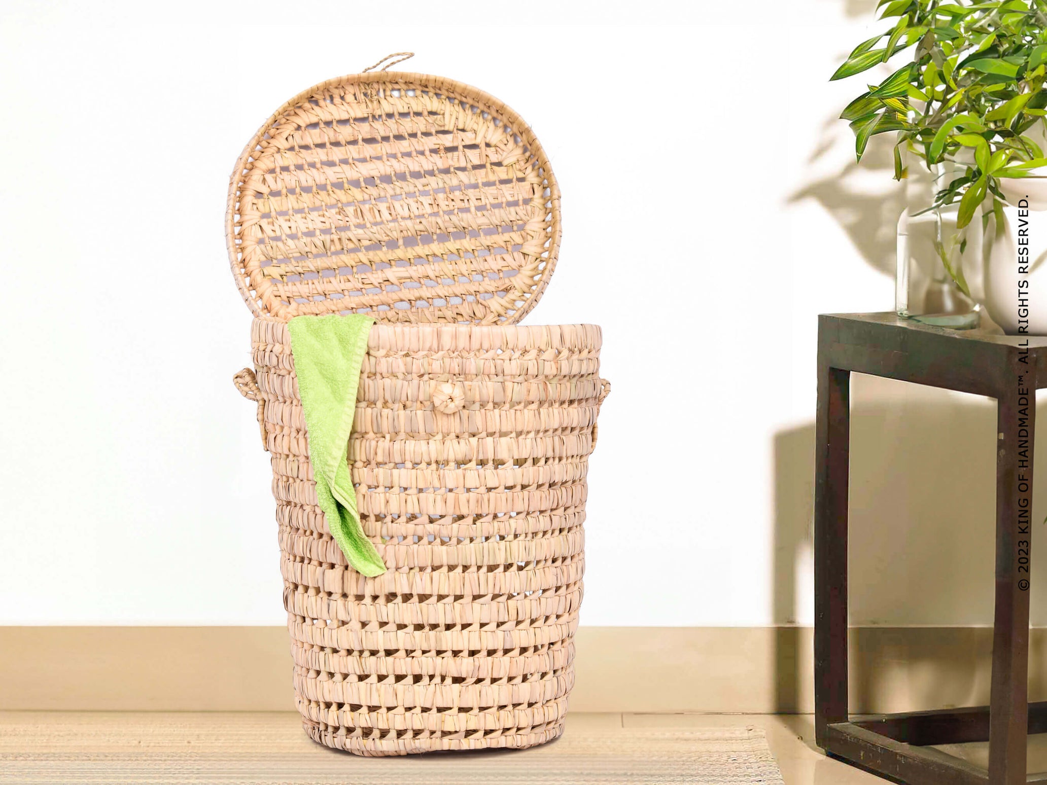 Chic woven toy storage basket with handles, perfect for a boho nursery setting