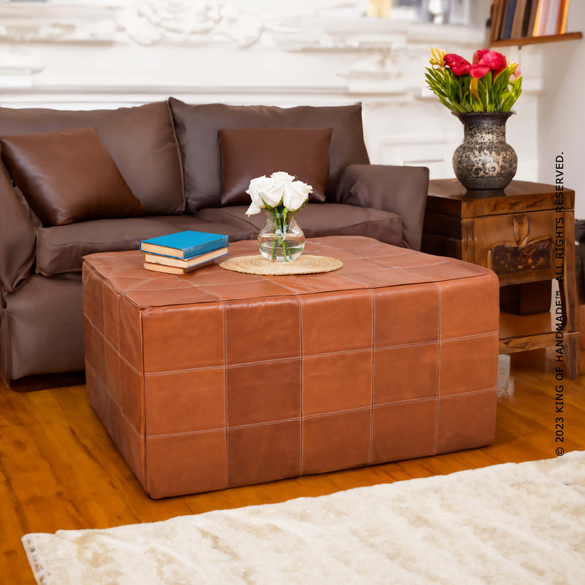 Handcrafted Moroccan leather pouf ottoman showcasing intricate details and versatile design