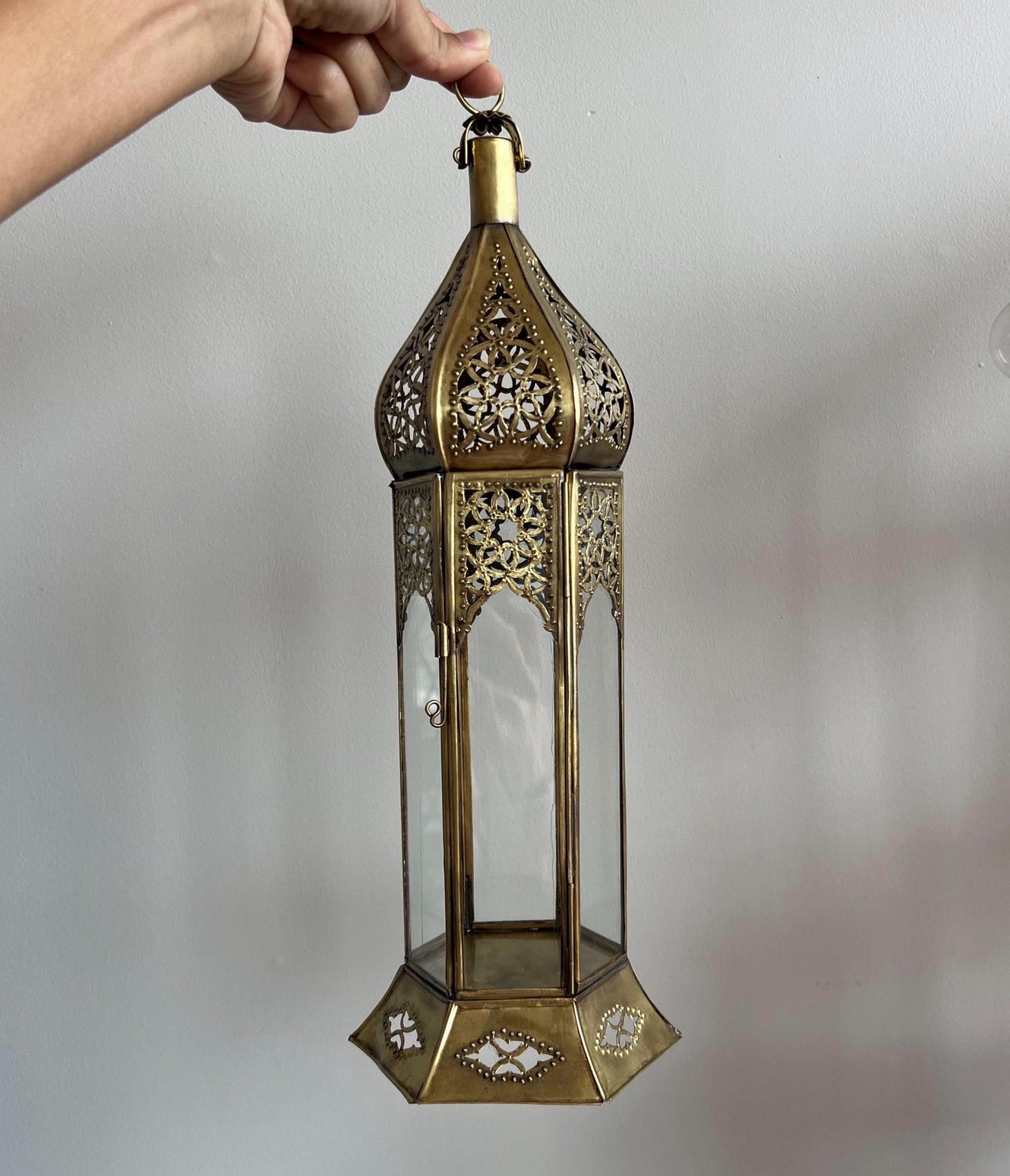 Large Moroccan Brass Candle Lantern with intricate patterns casting light