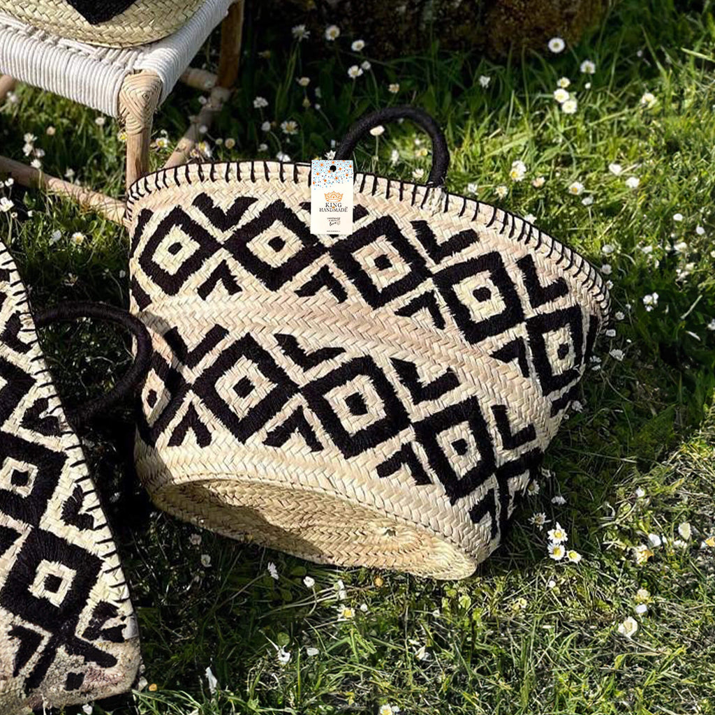 Handcrafted Moroccan straw bag with intricate black pattern