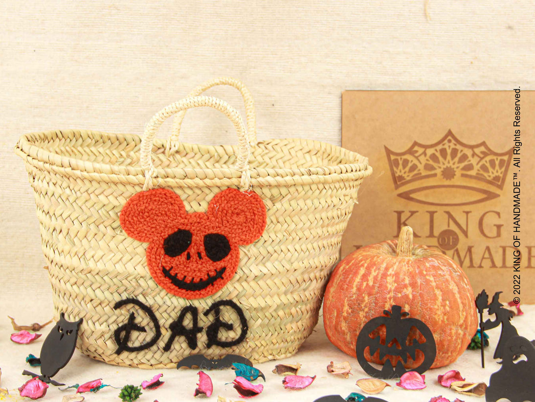 Festive Halloween pumpkin basket filled with candy and decorative items