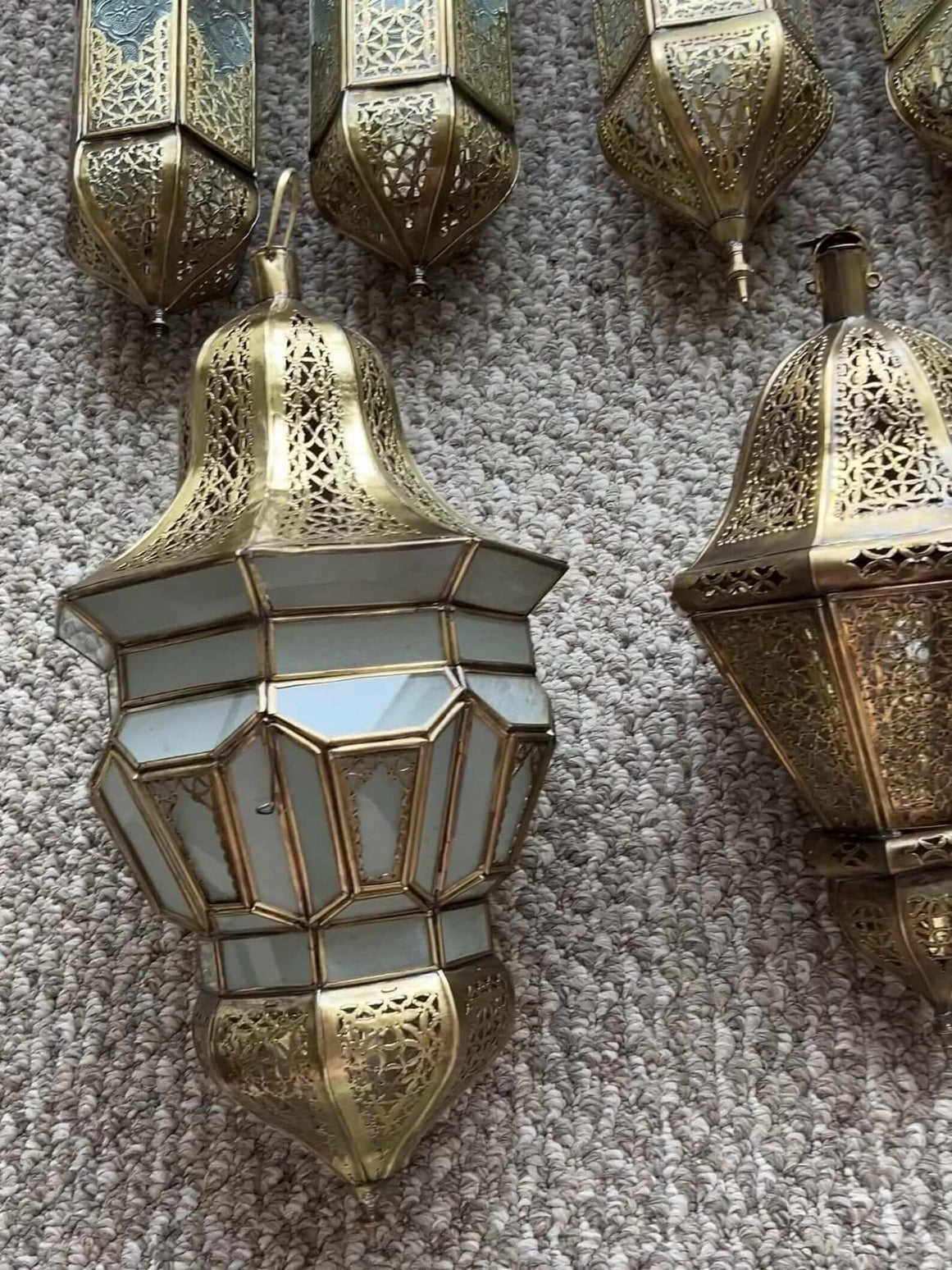 Beautiful Moroccan brass hanging lantern with intricate patterns and colorful glass inserts