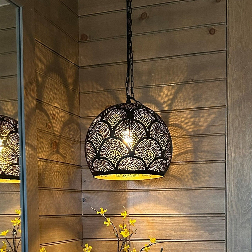 Black and brass moroccan pendant light on a ceiling