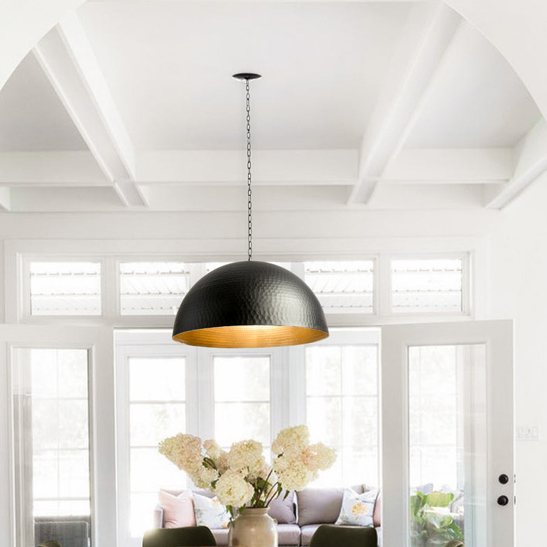 A stunning, handcrafted black chandelier with intricate metalwork and a candle-style design, perfect for adding a touch of elegance to any modern dining room.