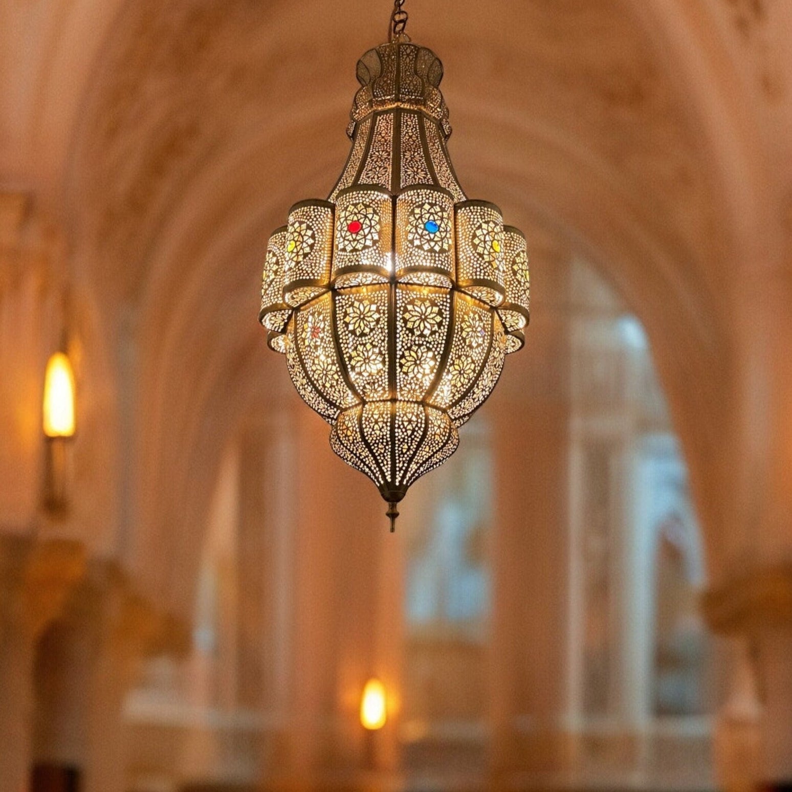 Elegant Moroccan brass chandelier illuminating a room with warm, ambient light