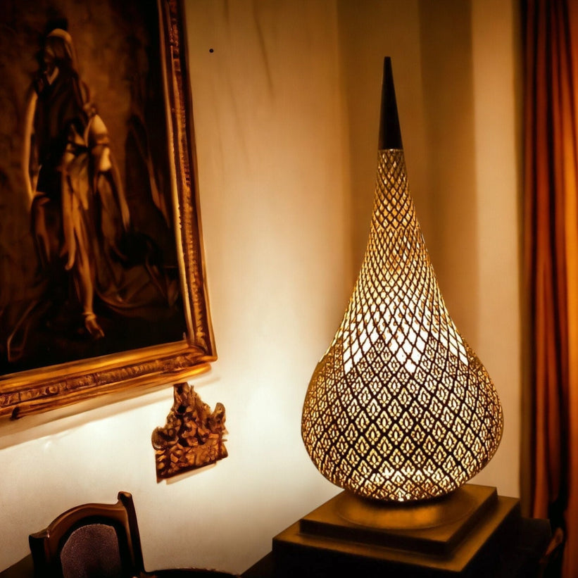 Vintage brass chandelier with crystal dangles lit up and hanging in a room