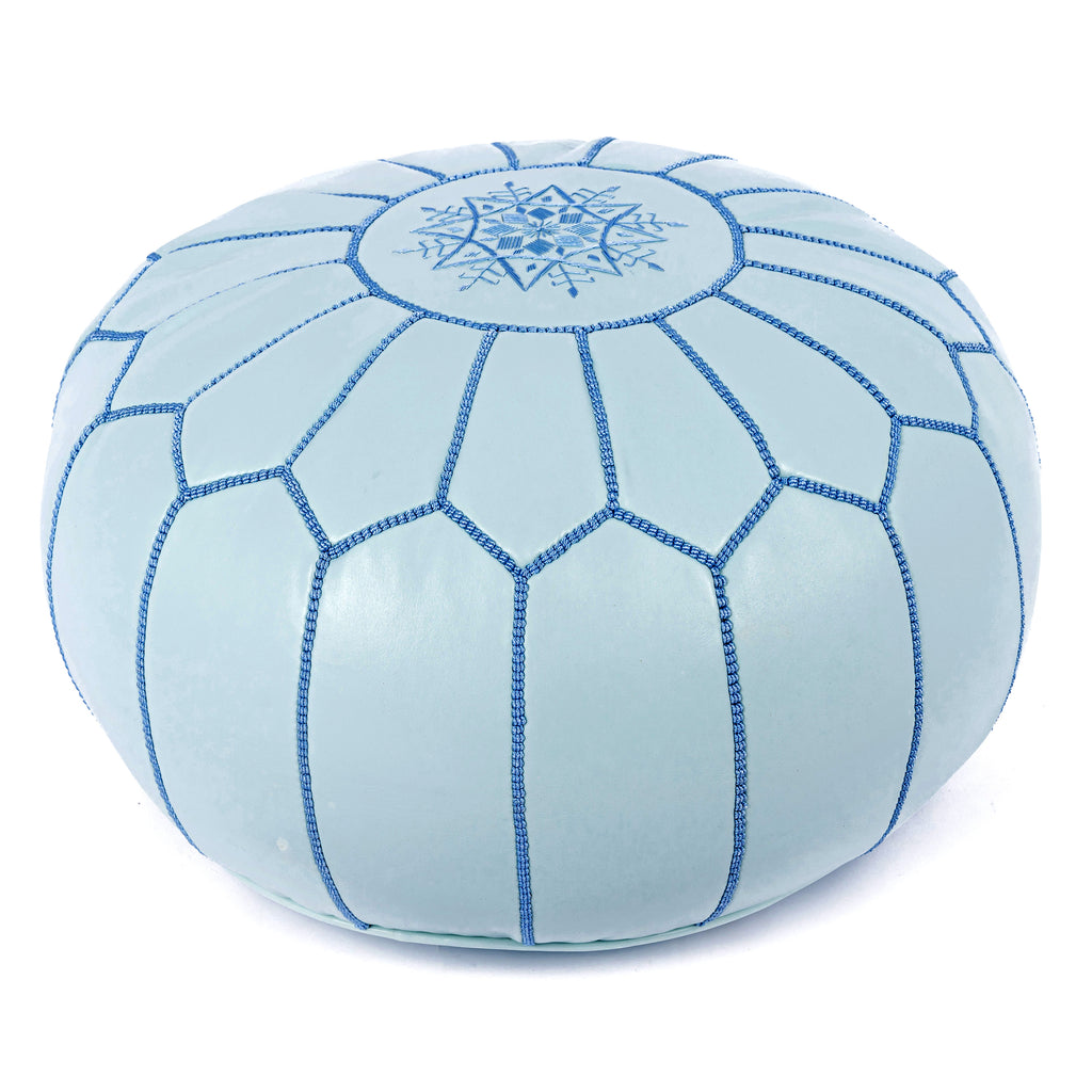 Assortment of colorful Moroccan leather poufs in a living room