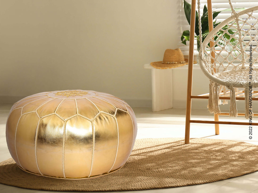 Gold faux leather ottoman pouf in a living room setting