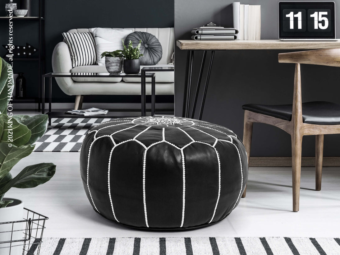 Moroccan genuine leather pouf used as a footstool in a boho-inspired living room setting