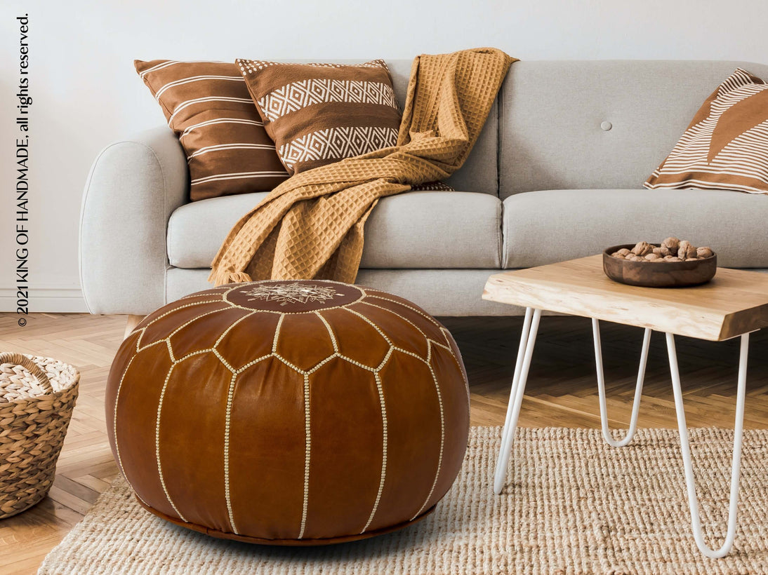 Dark tan leather Moroccan pouf in a modern living room