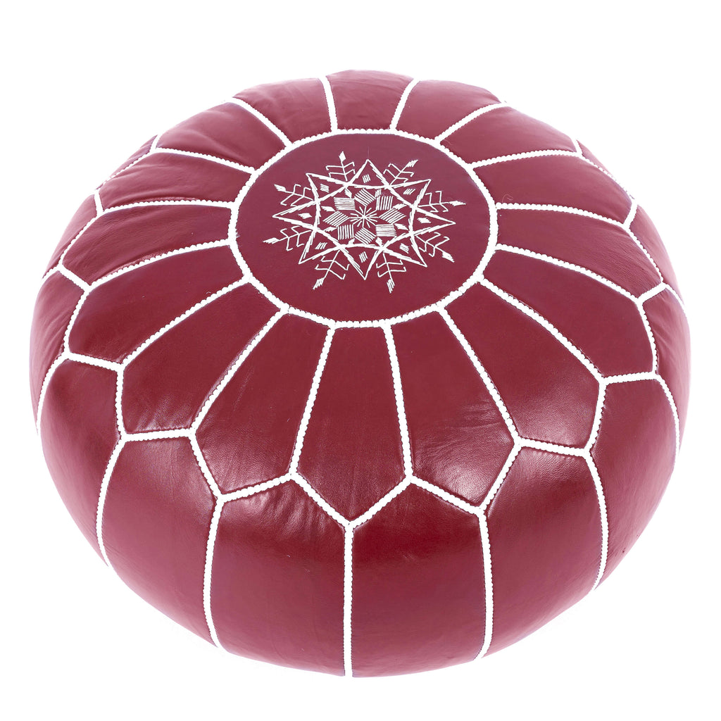 Stylish red Moroccan leather pouf in a living room setting