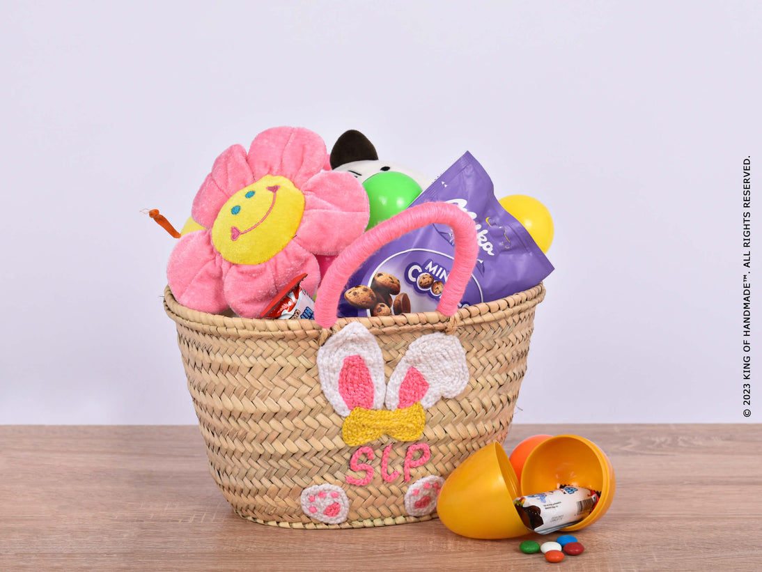 Handcrafted Easter Basket filled with colorful Easter grass and containing various Easter-themed items like chocolate eggs, plush bunnies, and festive decorations